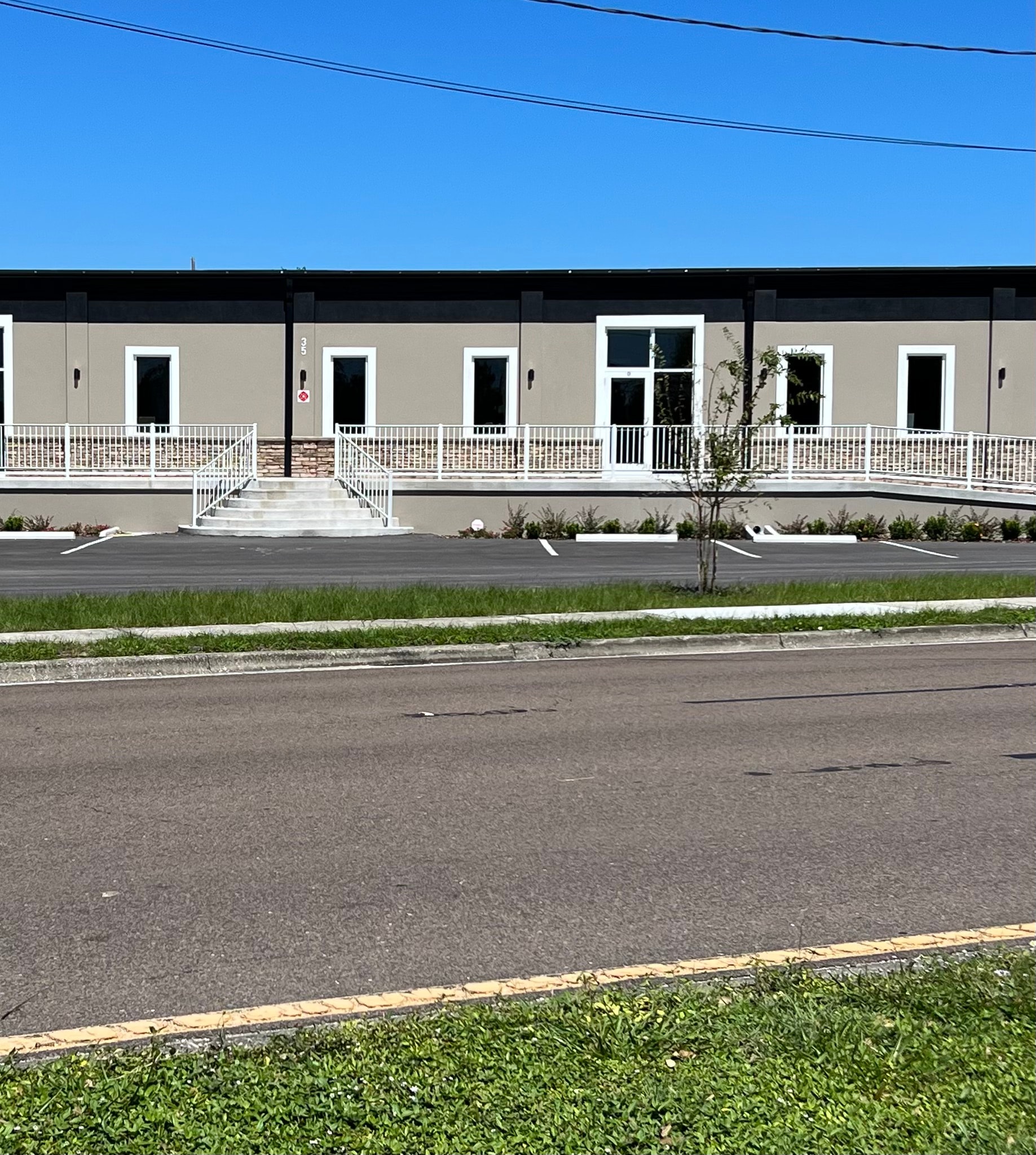 White ARM railing system on commercial building frontage
