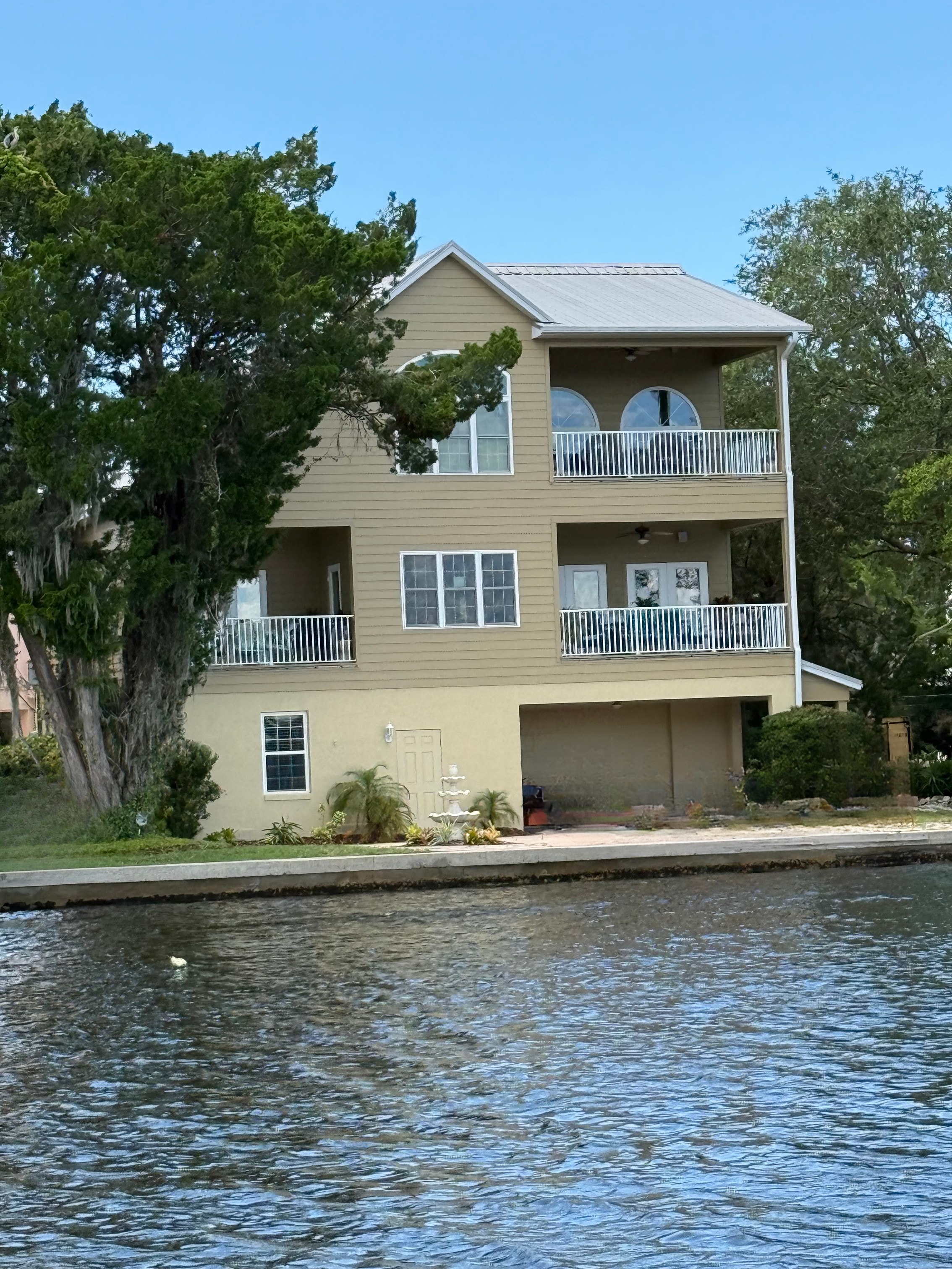 White ARM railing on multi-story waterfront river house